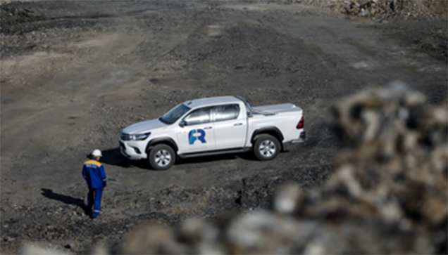 An employee of ferro-alloy resources group by a company car